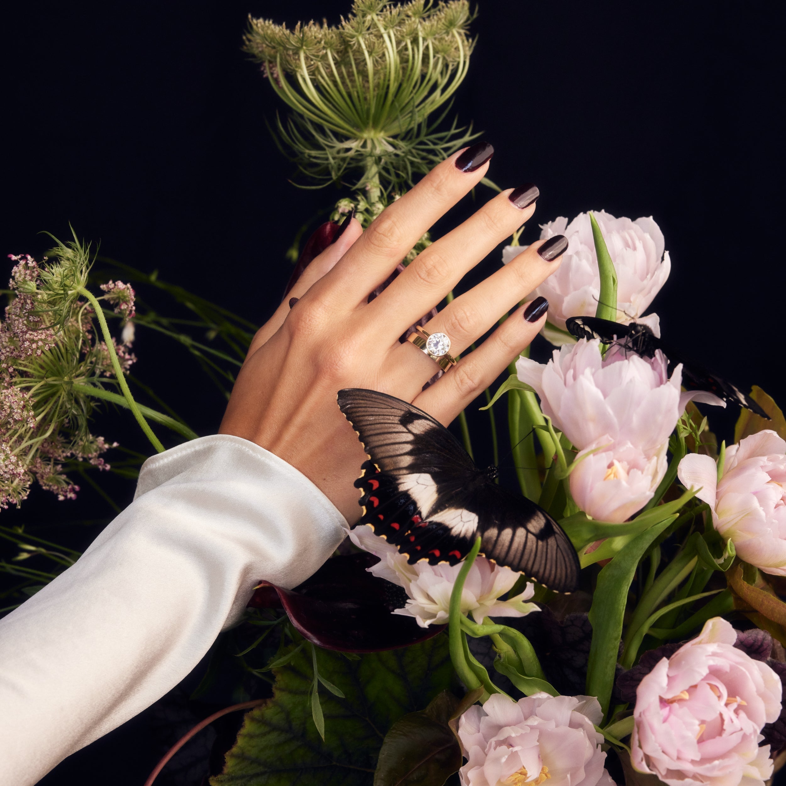 Old European Cut Round Moissanite Bezel Set Solitaire Engagement ring on hand in flowers with butterfly